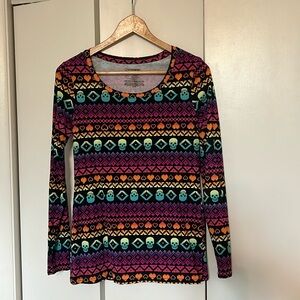 Long sleeve shirt. Black background with multicolor skull and heart detail.